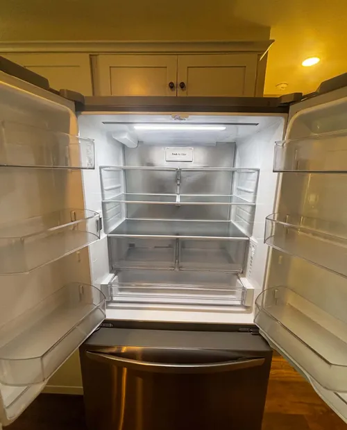 Empty, spotless refrigerator ready for the next tenant
