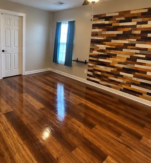 Empty living room with accent wall, spotless floors