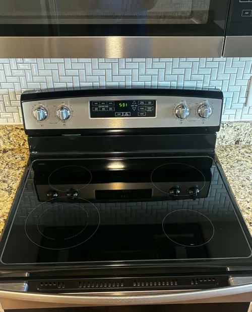 Detail-cleaned glass-top stove and range, no cooking residue